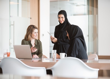 HR professionals having a discussion around a table.