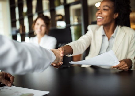 Professionals shaking hands across a table