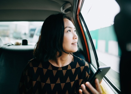 A busy CEO keeps track of her global workforce from the back of a cab because of the Pebl Global Work Platform™