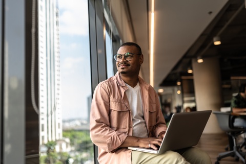 HR manager looking out the window while researching work visas in Egypt