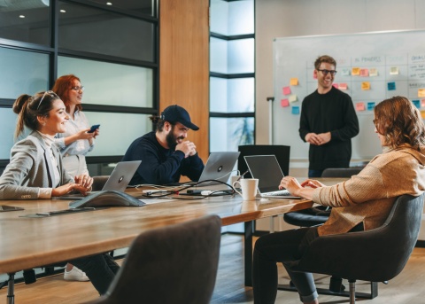 Coworkers in a conference room displaying collaboration in the workplace