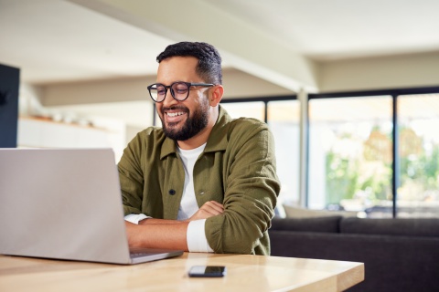 Global HR manager smiling while reading about Guinean work visas