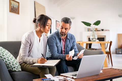 Mature couple at home calculating payroll taxes in Taiwan