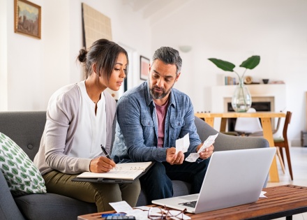 Mature couple at home calculating payroll taxes in Taiwan