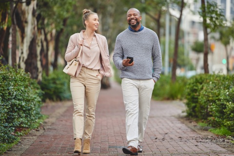Two businesspeople walking outside and chatting about salary in Lesotho