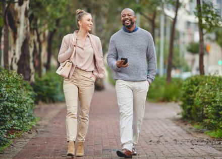 Two businesspeople walking outside and chatting about salary in Lesotho