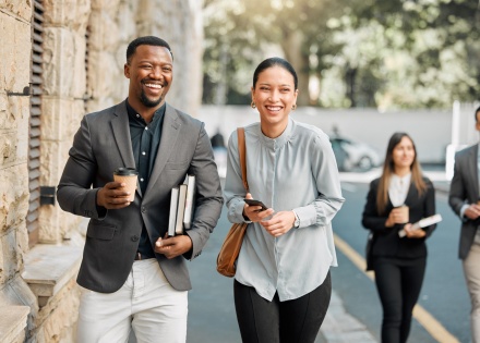 Two professionals walking to work while discussing salary in Kenya