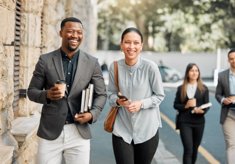 Two professionals walking to work while discussing salary in Kenya