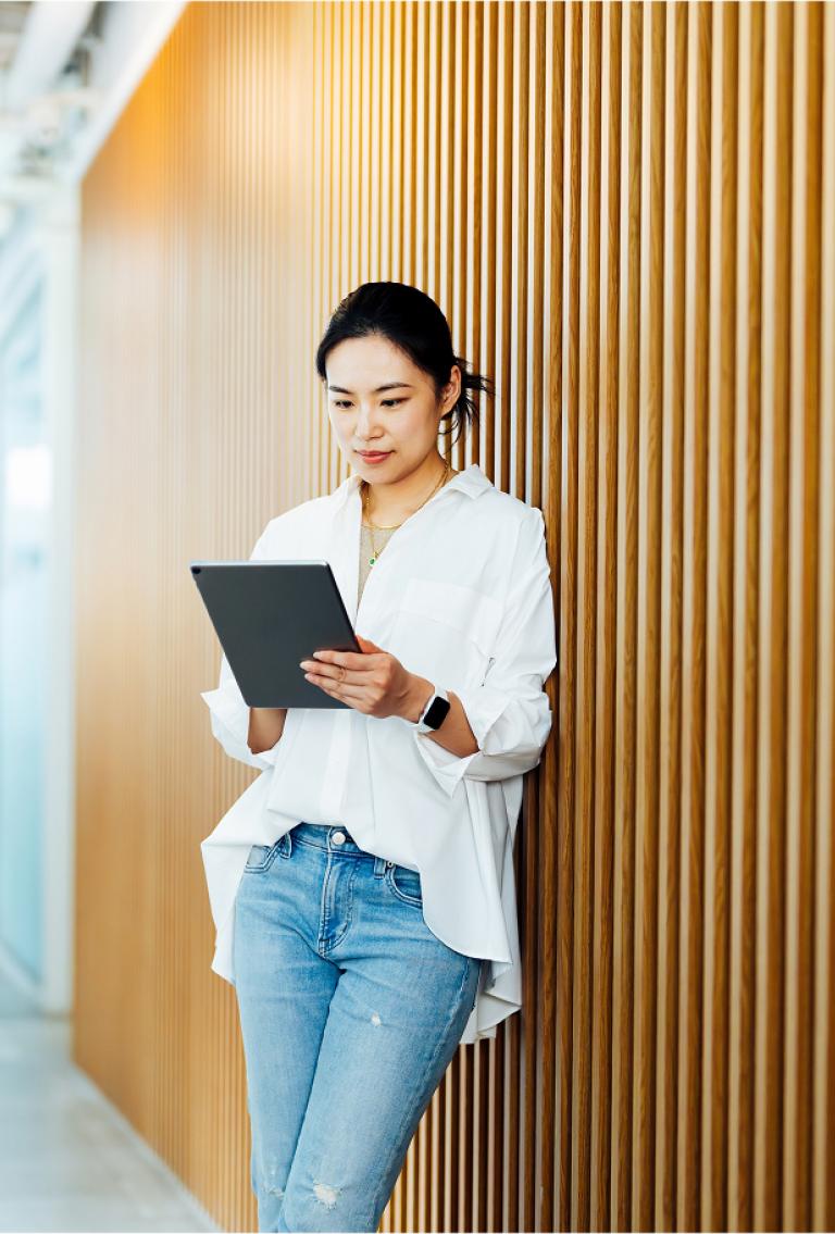 Employee walking through an AI company office with a laptop, representing how Pebl supports AI companies
