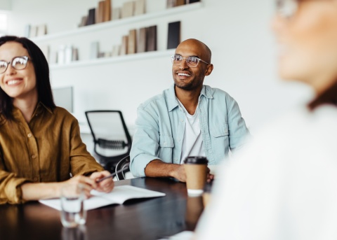 HR leaders at a conference room table collaborating on a strategic workforce plan 