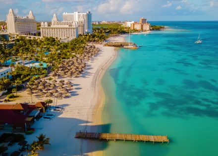 Aerial perspective of a white sand beach and resorts in Aruba