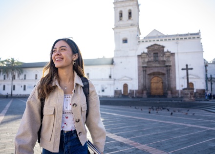 Woman standing in Santo Domingo church plaza in Quito Ecuador