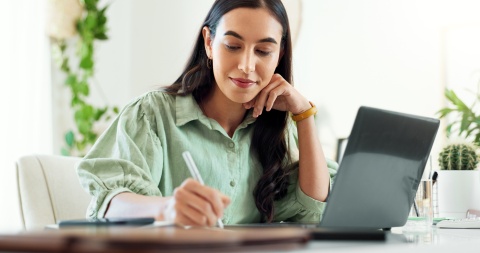 Woman working in home office with laptop