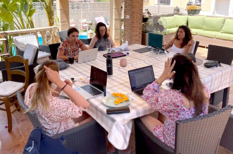Pebl colleagues working poolside at the Co-Work World Retreat