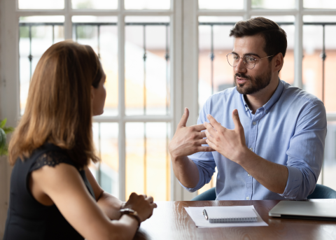 Two people in an office-setting discussing HCM Strategy